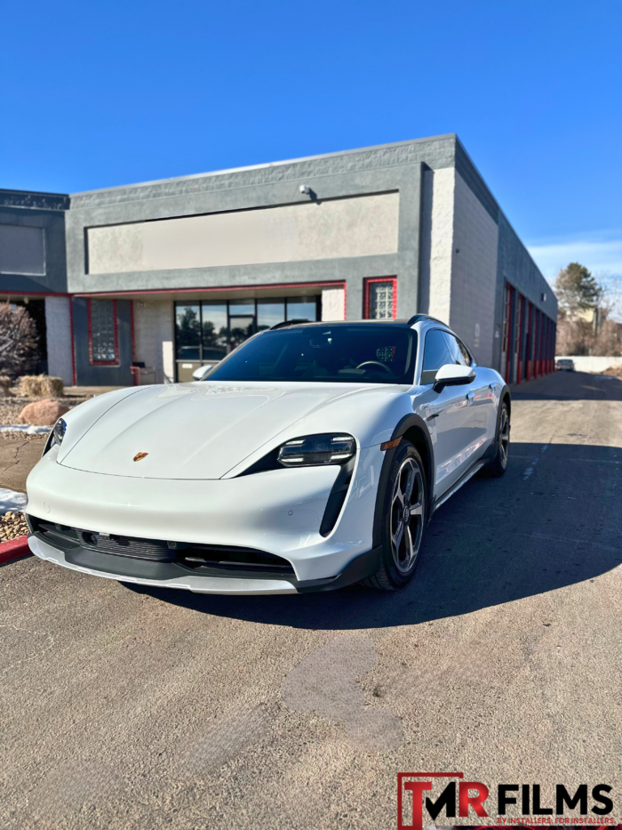 White Porsche with clear glossy paint protection film for enhanced shine and surface protection.